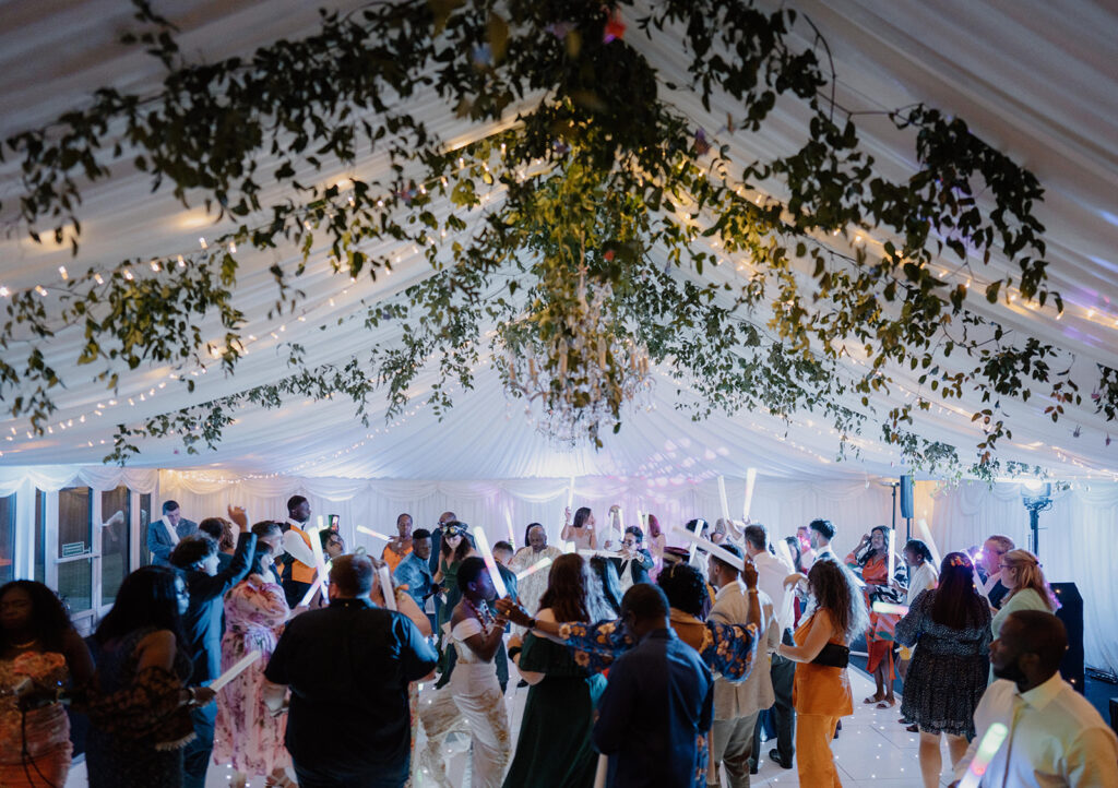 Marquee wedding flowers - large flower installation - ceiling greenery